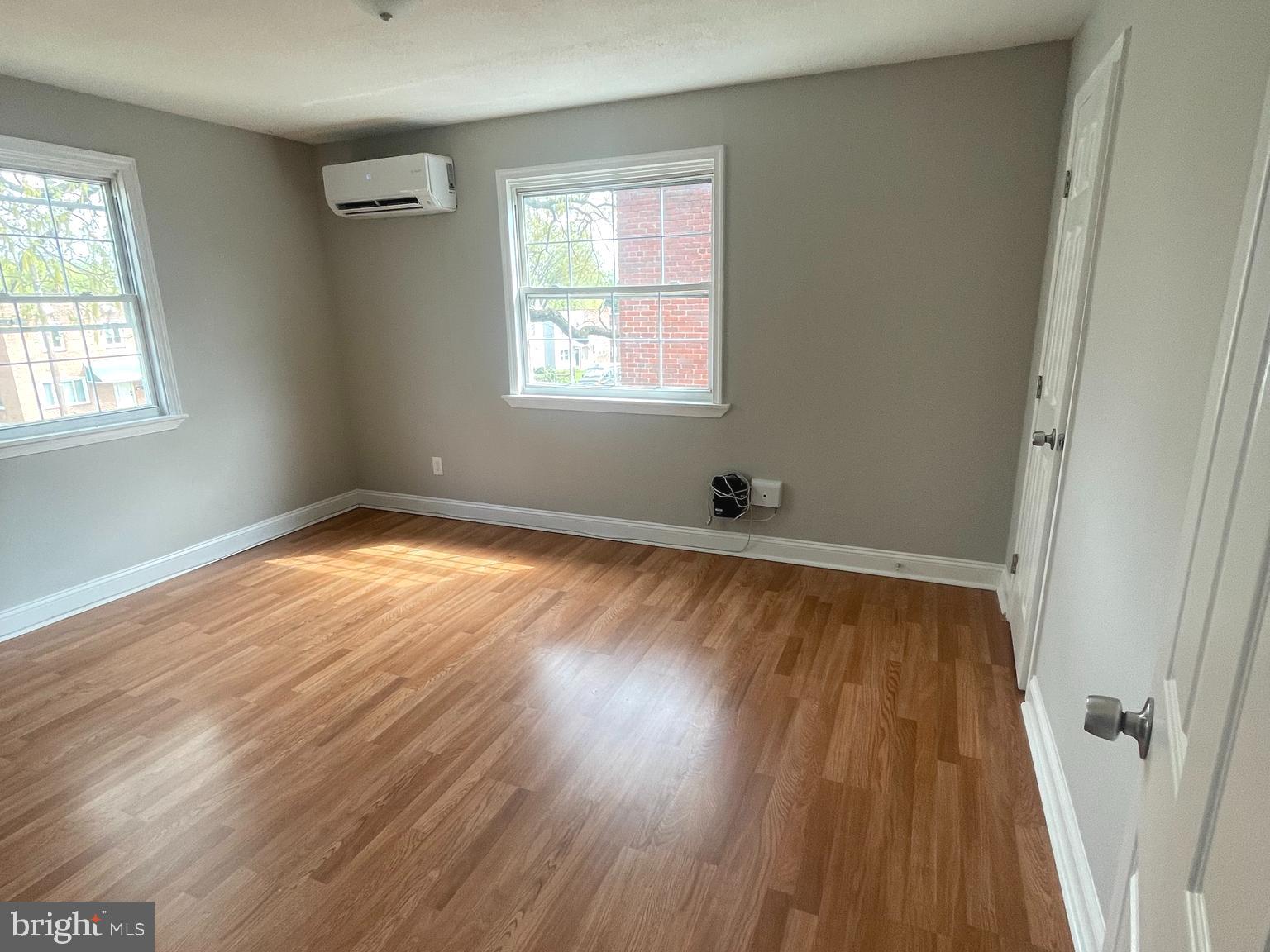 8528 Chestnut Oak Road, Unit B Baltimore, MD 21234 - Photo 3 of 15 an empty room with wooden floor and windows