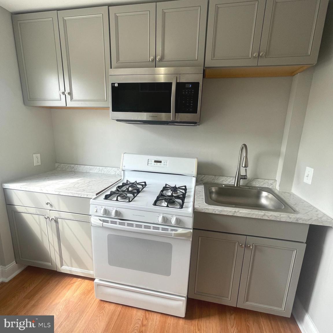 8528 Chestnut Oak Road, Unit B Baltimore, MD 21234 - Photo 5 of 15 a kitchen with stainless steel appliances granite countertop a sink a stove and a microwave