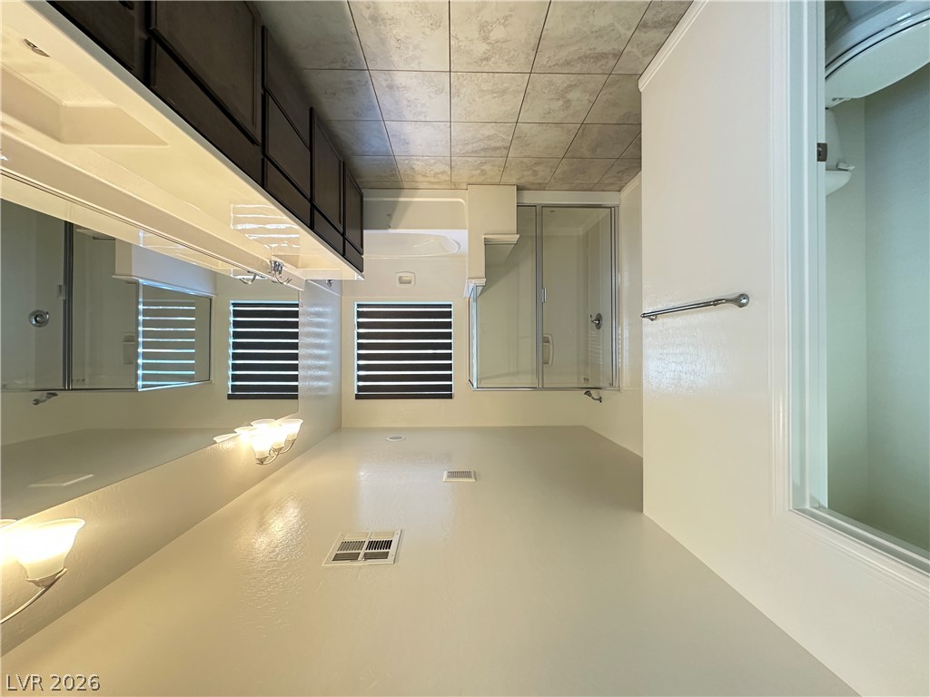 6784 Pivot Point Street Las Vegas, NV 89148 - Photo 16 of 27 A well-lit bathroom provides a glass-enclosed shower and spacious vanity area.
