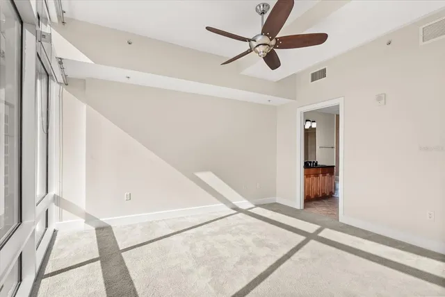 a view of a room with a ceiling fan