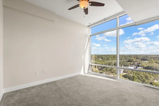 an empty room with windows and city view