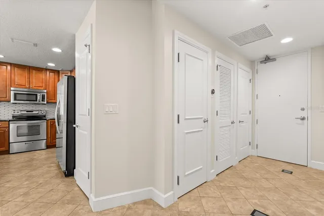 a view of kitchen with a refrigerator and a sink