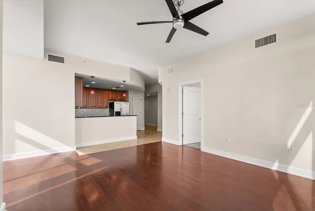 a view of a kitchen and a sink window wooden floor and a kitchen space