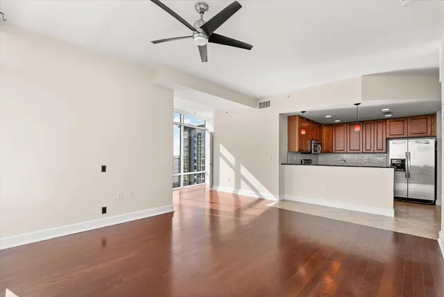 a view of a kitchen with wooden floor and electronic appliances