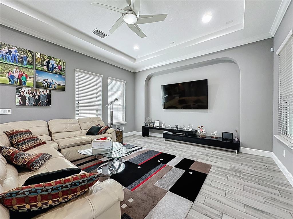 107 Balmy Coast Road Groveland, FL 34736 - Photo 12 of 97 a living room with furniture and a flat screen tv