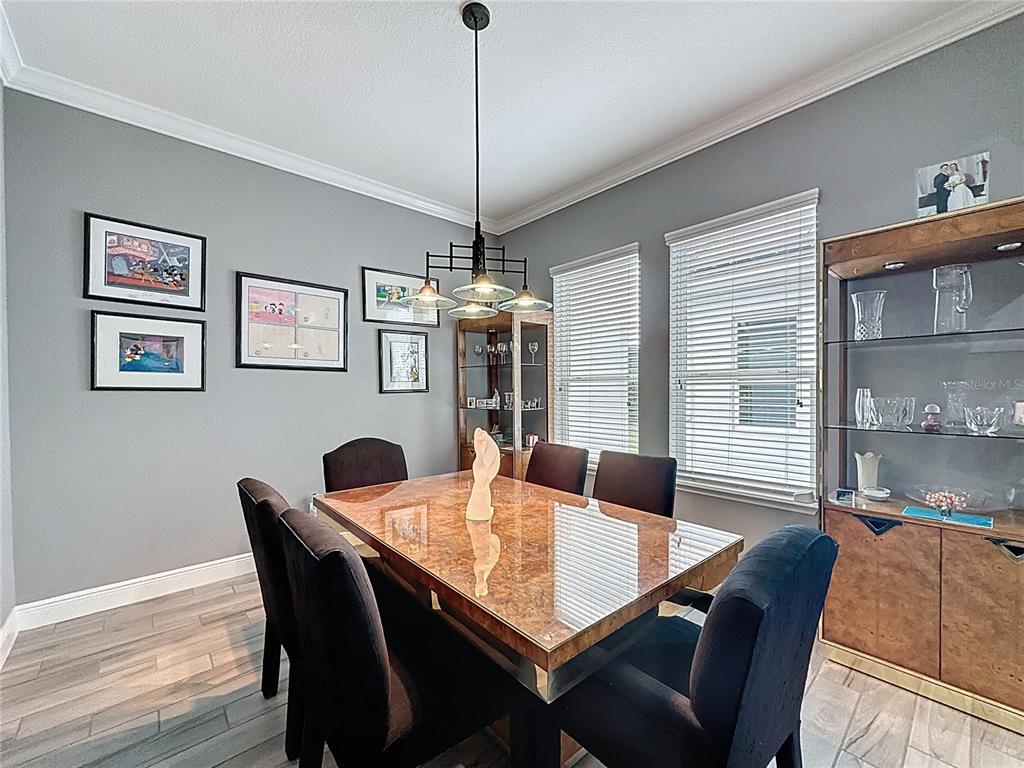 107 Balmy Coast Road Groveland, FL 34736 - Photo 19 of 97 a view of a dining room with furniture window and wooden floor