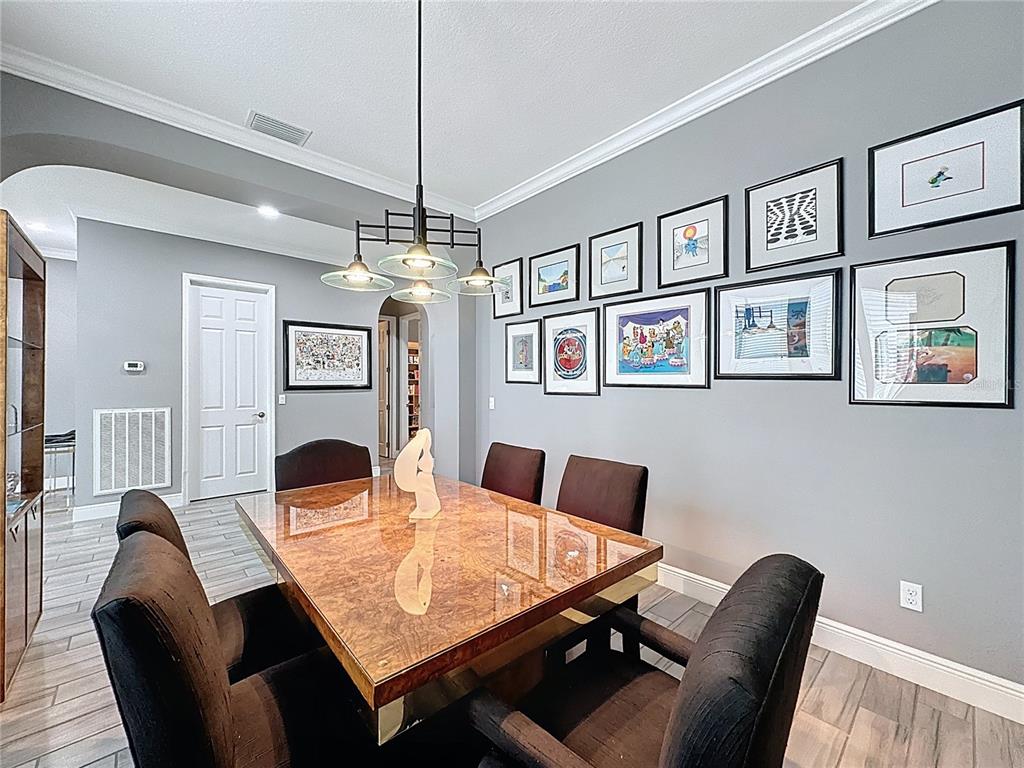 107 Balmy Coast Road Groveland, FL 34736 - Photo 21 of 97 a view of a dining room with furniture a chandelier and a window