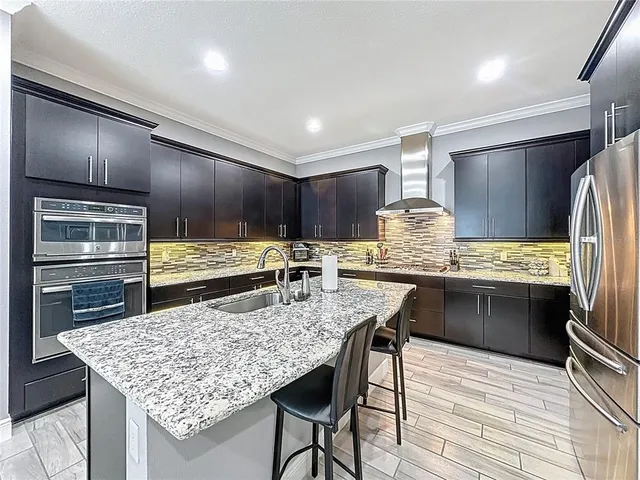 a spacious bedroom with a bed and a flat screen tv