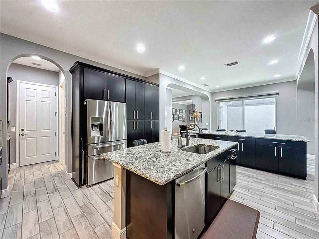 107 Balmy Coast Road Groveland, FL 34736 - Photo 24 of 97 a kitchen with stainless steel appliances granite countertop a sink and refrigerator