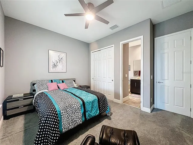 a living room with a large window and a book shelf