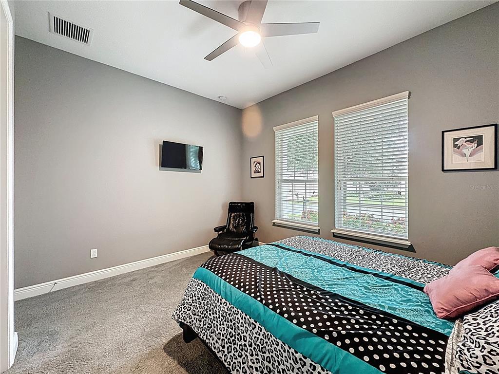 107 Balmy Coast Road Groveland, FL 34736 - Photo 33 of 97 a bedroom with a bed and a window