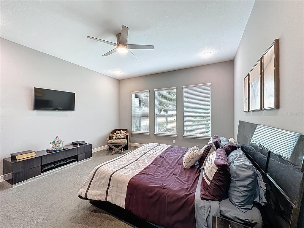 107 Balmy Coast Road Groveland, FL 34736 - Photo 37 of 97 a bedroom with a bed and a flat screen tv