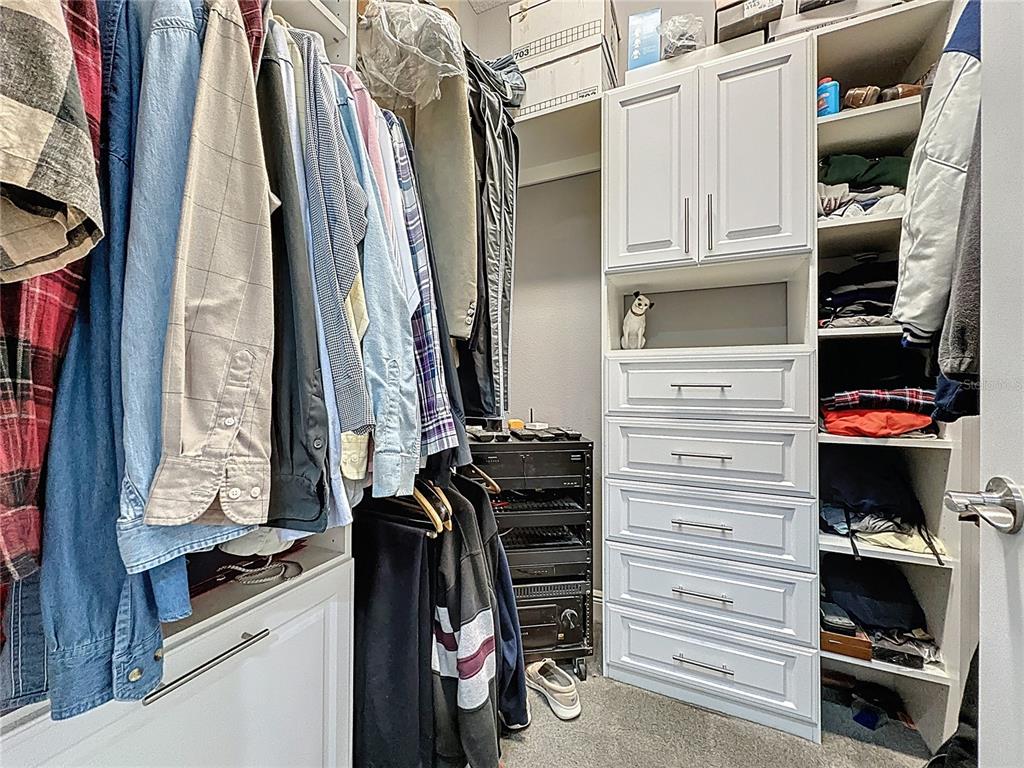 107 Balmy Coast Road Groveland, FL 34736 - Photo 43 of 97 a view of walk in closet with clothes and shoes