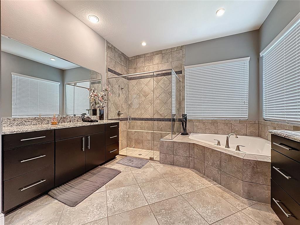 107 Balmy Coast Road Groveland, FL 34736 - Photo 47 of 97 a spacious bathroom with a tub sink shower and mirror