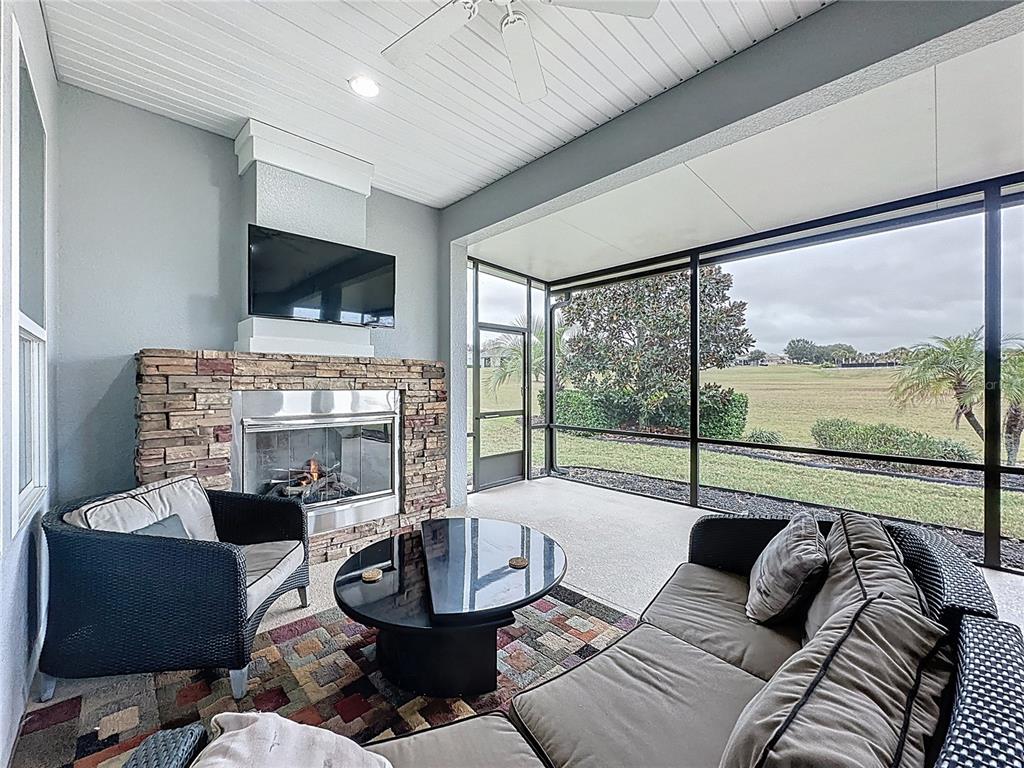 107 Balmy Coast Road Groveland, FL 34736 - Photo 59 of 97 a living room with fireplace furniture and a flat screen tv