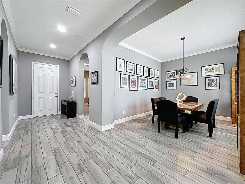 107 Balmy Coast Road Groveland, FL 34736 - Photo 9 of 97 a view of a dining room with furniture and chandelier