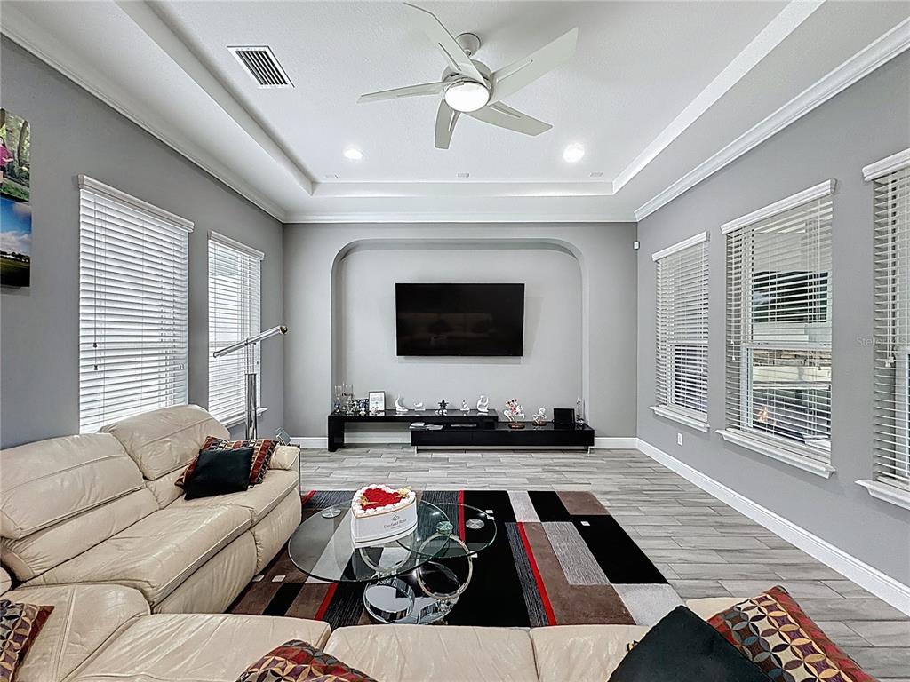 107 Balmy Coast Road Groveland, FL 34736 - Photo 10 of 97 a living room with furniture and a flat screen tv