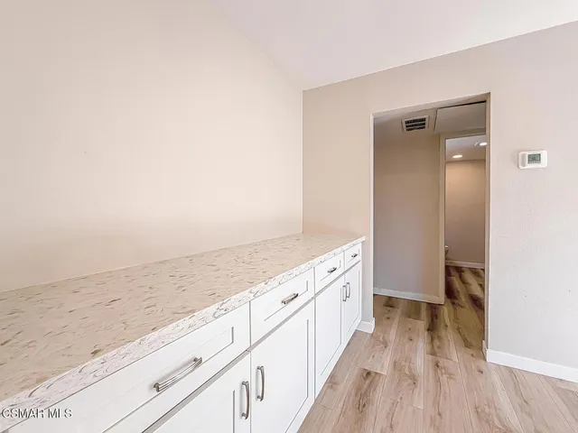 a view of a kitchen with wooden floor