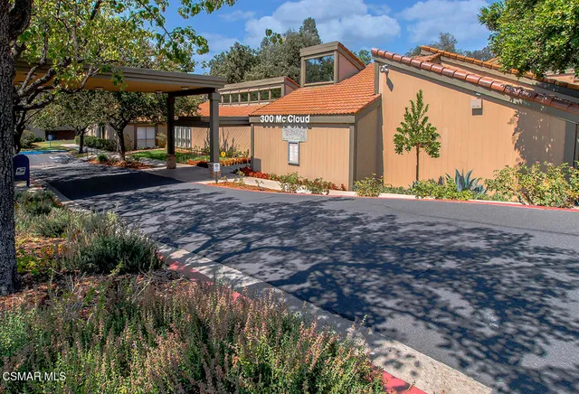 a view of a house with a yard and sitting area