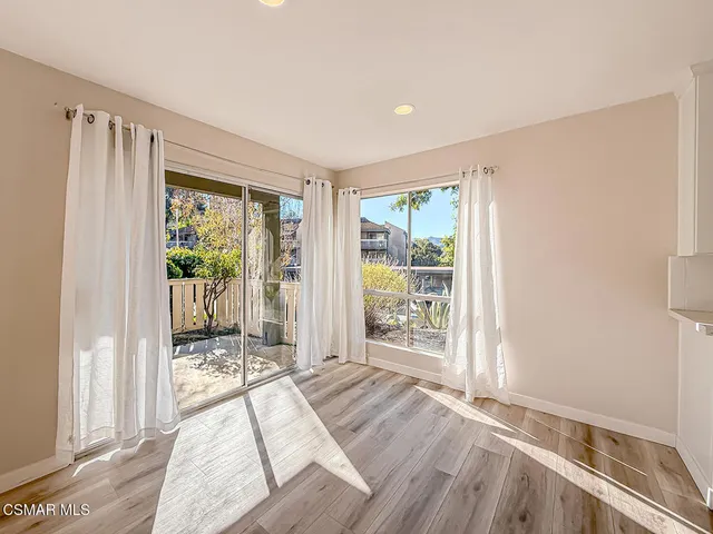 a bed room with a bed and a large window