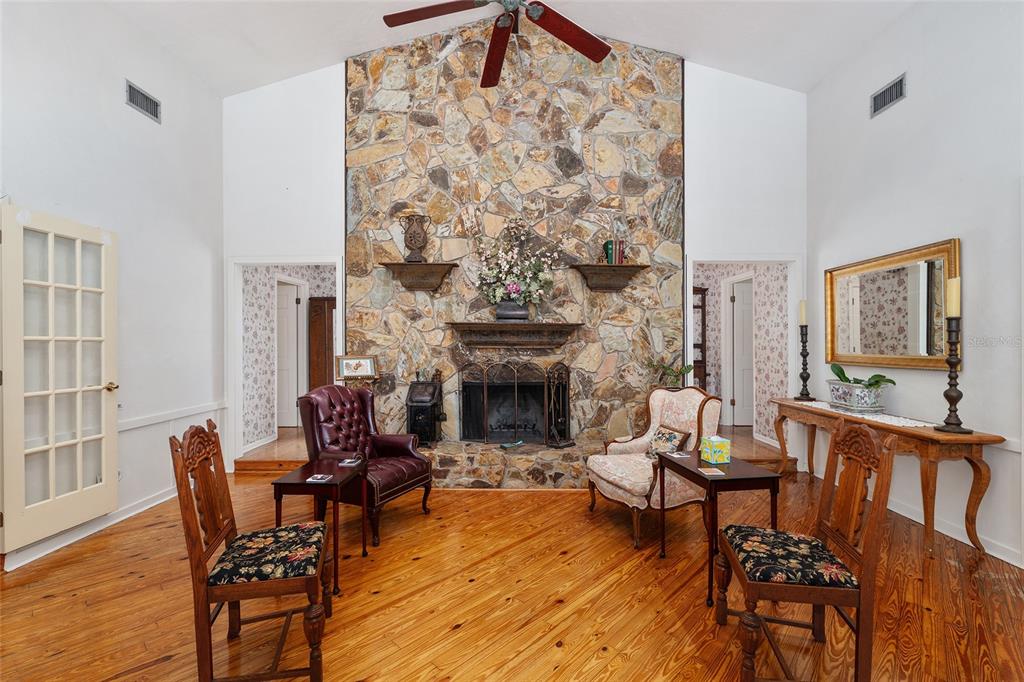 11427 Southwest 10th Terrace Micanopy, FL 32667 - Photo 15 of 77 a living room with furniture and a fireplace