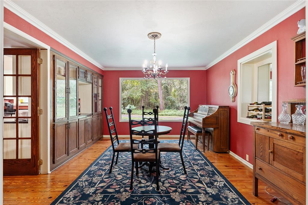11427 Southwest 10th Terrace Micanopy, FL 32667 - Photo 18 of 77 a dining room with furniture window and wooden floor