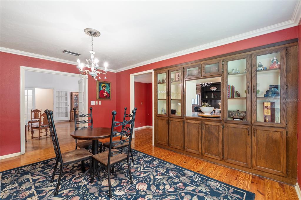 11427 Southwest 10th Terrace Micanopy, FL 32667 - Photo 22 of 77 a view of a dining room with furniture window and wooden floor