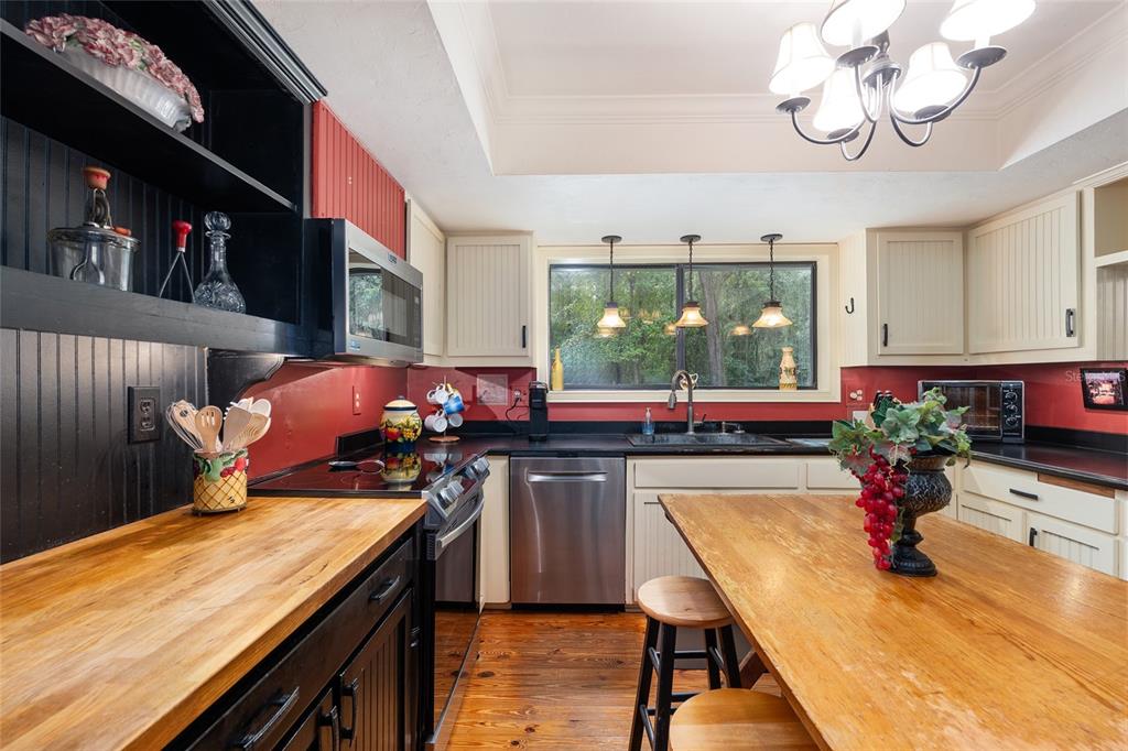 11427 Southwest 10th Terrace Micanopy, FL 32667 - Photo 23 of 77 a kitchen with a table and chairs in it