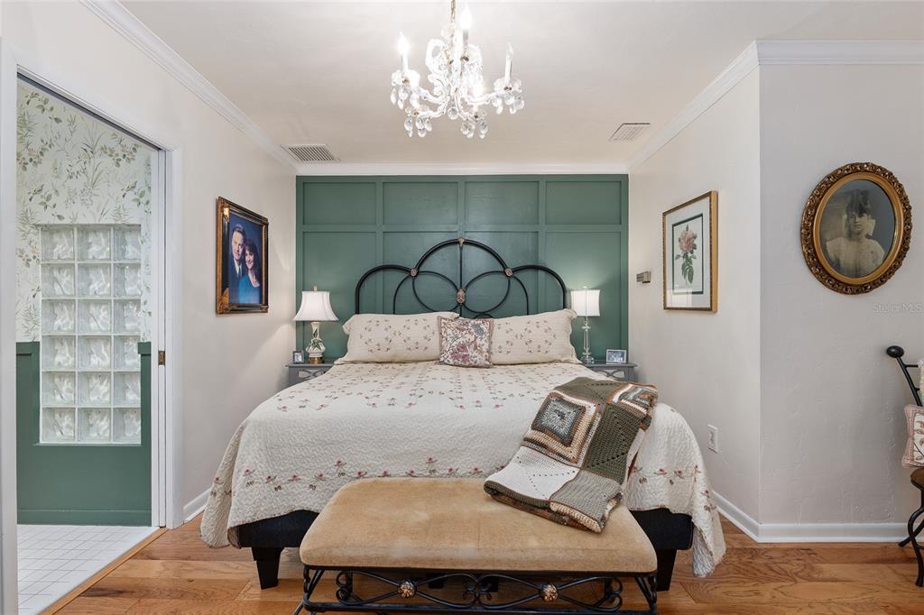 11427 Southwest 10th Terrace Micanopy, FL 32667 - Photo 37 of 77 a bed sitting in a bedroom next to a window with a chandelier