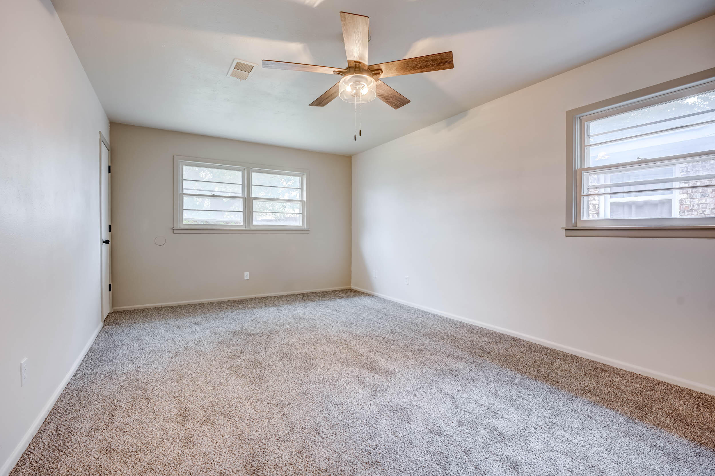 2101 64th Street Lubbock, TX 79412 - Photo 4 of 30 an empty room with windows and ceiling fan