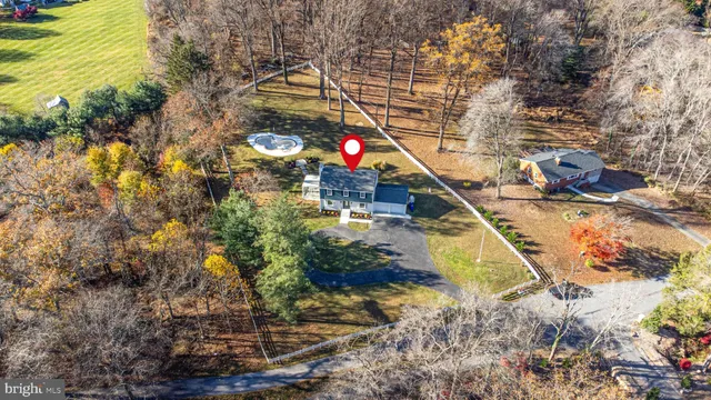 a front view of house with yard and trees around