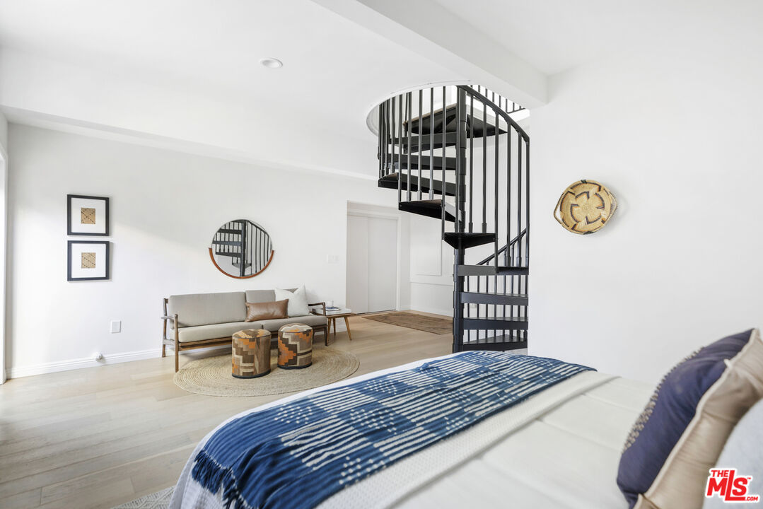 479 Crane Boulevard Los Angeles, CA 90065 - Photo 18 of 35 a bedroom with a bed and a chandelier