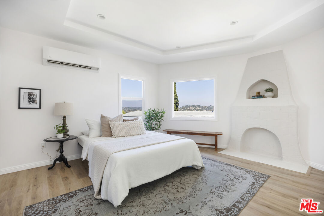 479 Crane Boulevard Los Angeles, CA 90065 - Photo 23 of 35 a bedroom with a bed a rug with wooden floor