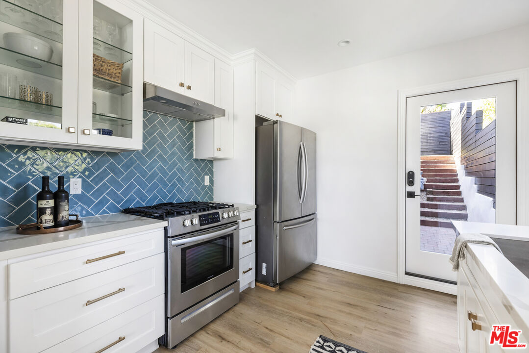 479 Crane Boulevard Los Angeles, CA 90065 - Photo 27 of 35 a kitchen with a stove and a refrigerator