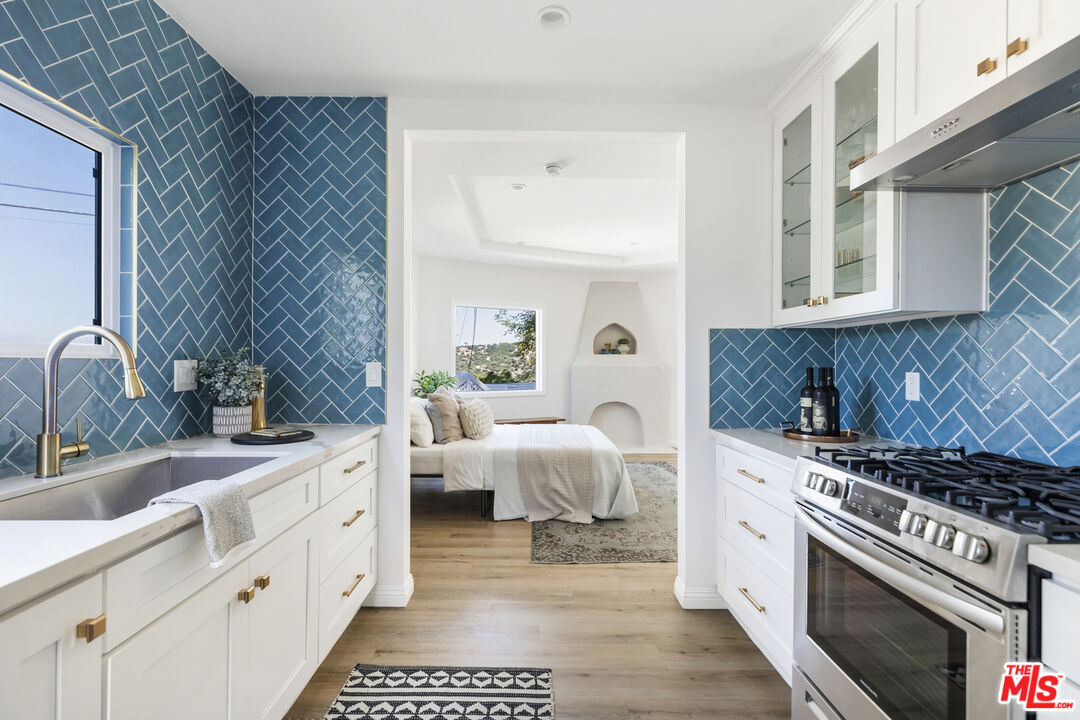 479 Crane Boulevard Los Angeles, CA 90065 - Photo 28 of 35 a kitchen with a sink stove and cabinets