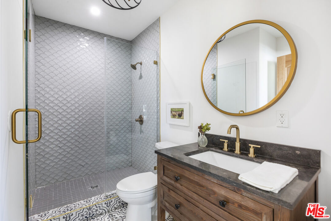 479 Crane Boulevard Los Angeles, CA 90065 - Photo 29 of 35 a bathroom with a granite countertop sink a toilet and a mirror