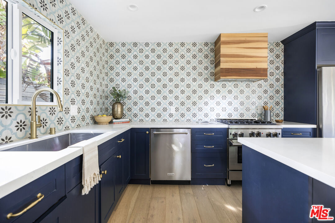 479 Crane Boulevard Los Angeles, CA 90065 - Photo 10 of 35 a kitchen with stainless steel appliances a sink and wooden cabinets