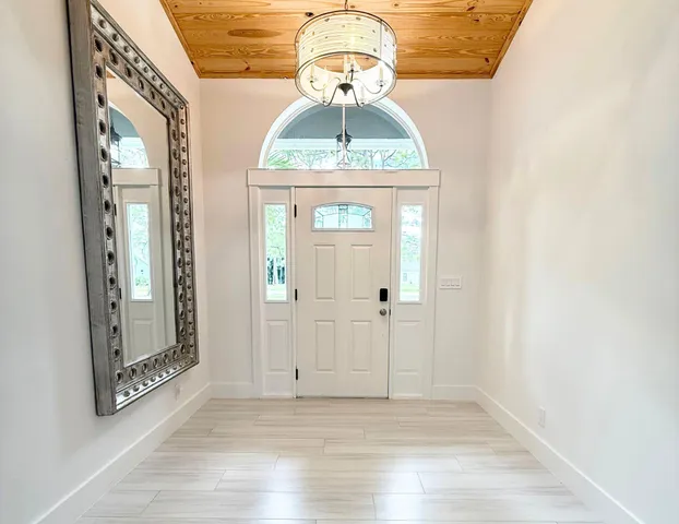 a view of a entryway door with wooden floor