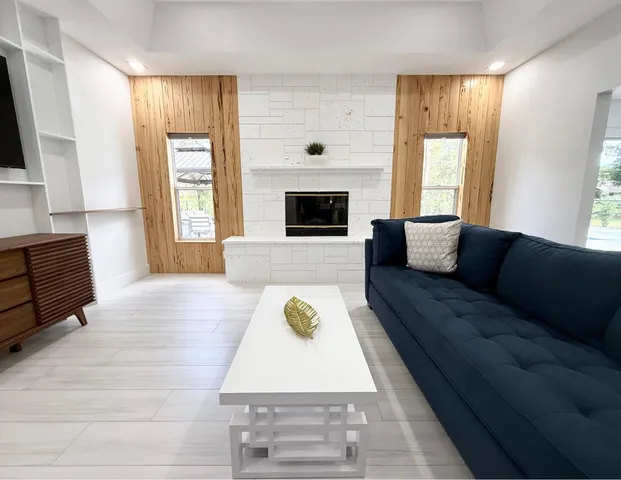 a living room with furniture and a fireplace