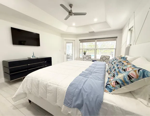 a bedroom with a bed and a flat screen tv