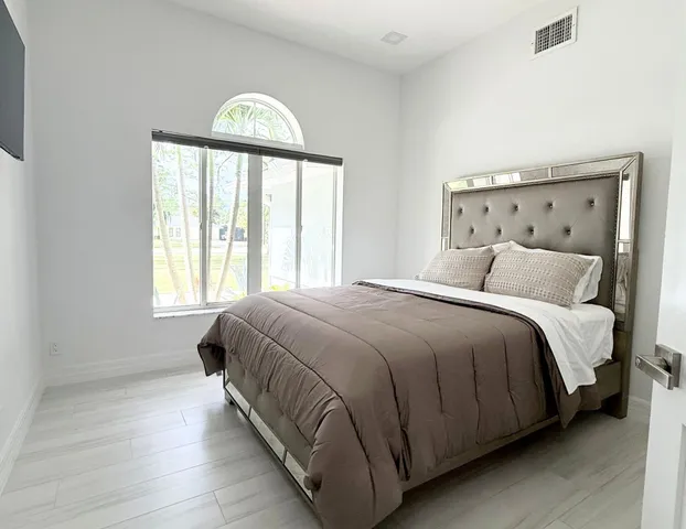 a bedroom with a bed and a window