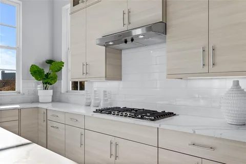 a kitchen with stainless steel appliances white cabinets and a stove