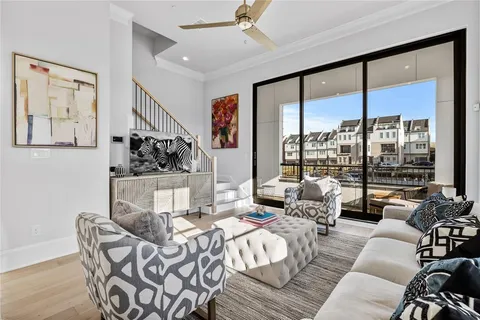 a living room with furniture and large windows