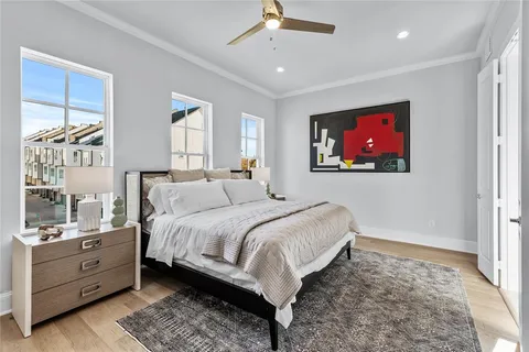 a spacious bedroom with a bed and a flat screen tv
