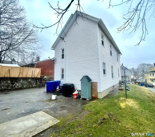a view of a backyard with a white house