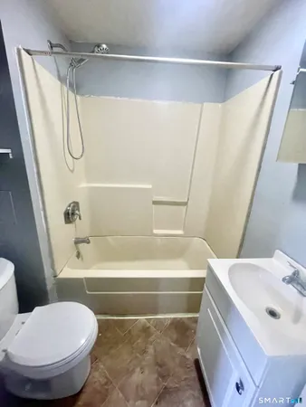 a bathroom with a toilet and a bathtub