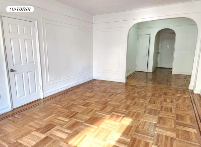 a view of empty room with wooden floor