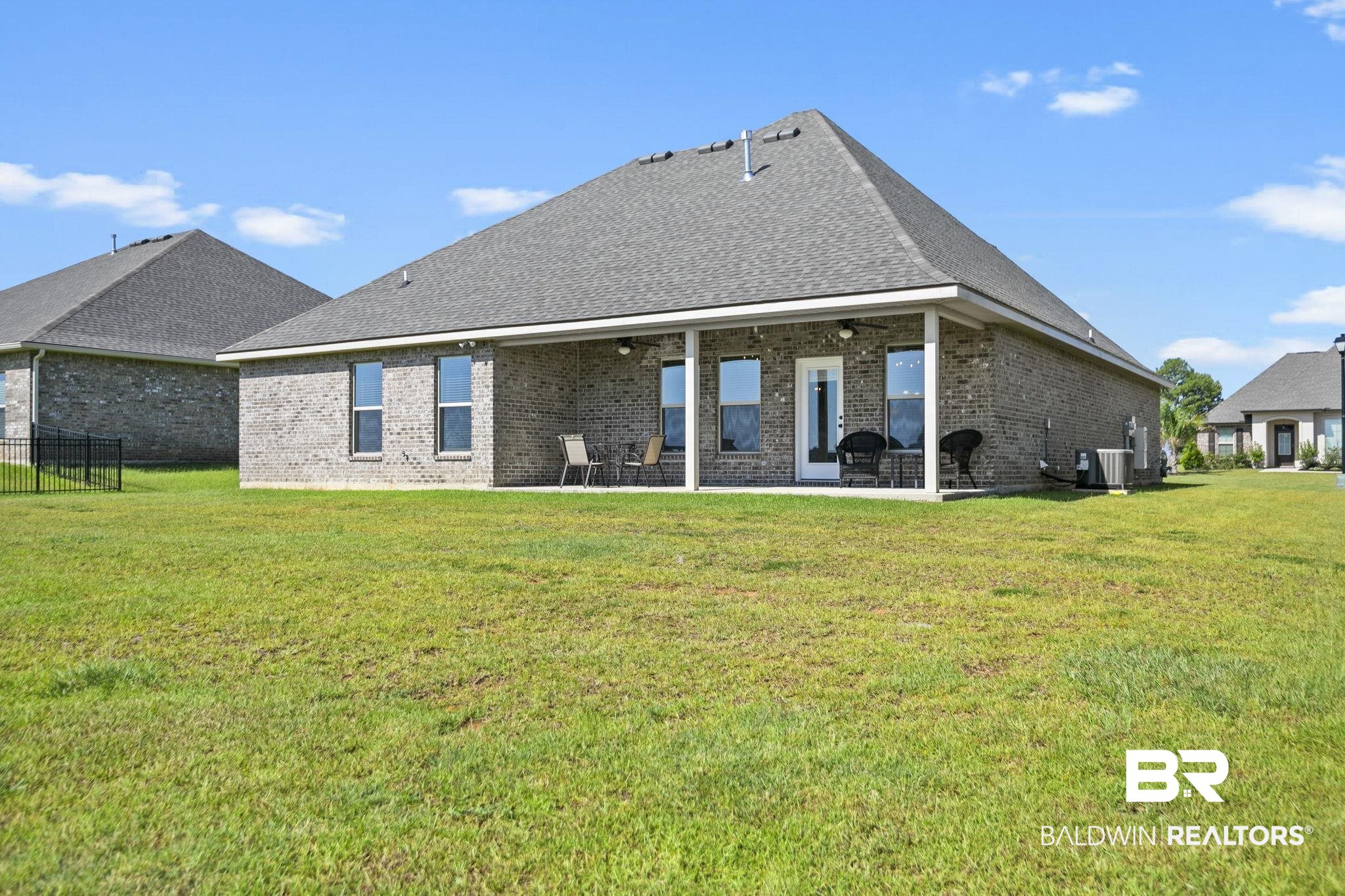 10140 Chipper Lane Foley, AL 36535 - Photo 44 of 72 Back of property featuring a patio and a lawn