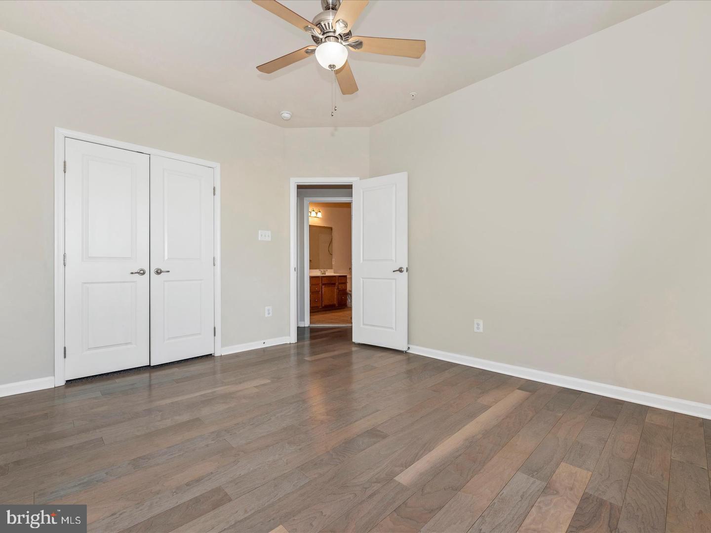 208 B Mill Pond Road Frederick, MD 21701 - Photo 31 of 45 a view of an empty room with wooden floor
