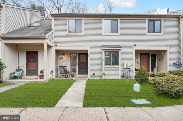a front view of a house with a garden and yard